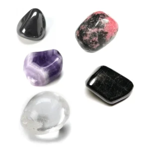Top-down studio view of five polished natural tumbled crystals for the Aquarius zodiac sign arranged cleanly on a solid white background.