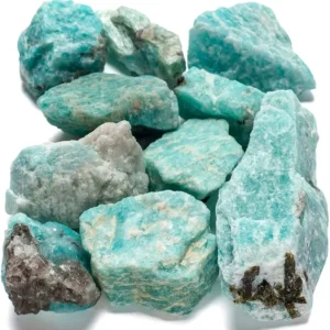 A large pile of natural raw Amazonite crystal chunks, displaying vibrant teal and turquoise-green hues with earthy brown and white inclusions, set against a white background.
