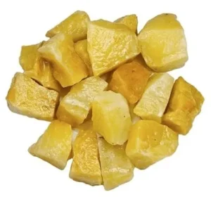 A scattered pile of unpolished, natural raw yellow aventurine crystal chunks resting on a seamless white background, showcasing their bright, waxy yellow color and blocky, textured surfaces