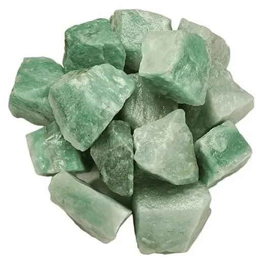 A top-down view of a pile of unpolished, raw green aventurine crystal chunks resting on a white background, showcasing their opaque, pale to medium green hues and rough, natural textures.