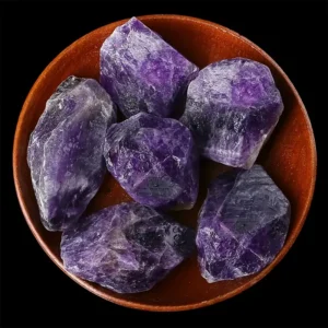 A graphic card outlining the metaphysical healing properties of Amethyst, including spiritual awareness, psychic abilities, and inner peace, layered over a close-up background of a bright purple amethyst cluster