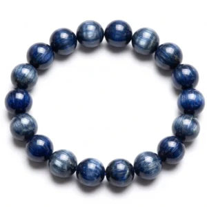 Top-down commercial product photograph of a natural, premium gem-grade Blue Kyanite 11mm beaded bracelet made of approximately eighteen (18) perfectly round beads on a pure #FFFFFF white background. The stunning beads showcase deep, rich sapphire-blue, royal blue, and dark indigo hues with intense chatoyant fibrous grain and silky chatoyancy that flash brilliantly under light. Highly polished to a mirror-like, glassy luster, capturing the mineral's natural bladed structure and striking directional light reflections, ideal for Throat and Third Eye Chakra alignment.