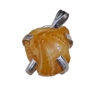 A natural, raw orange Machh Mani gemstone mounted in a classic silver locket pendant setting, isolated on a pure white background to showcase its unique organic texture.