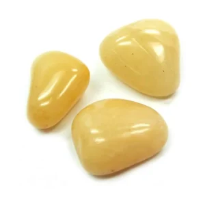 Three smooth, high-gloss natural Yellow Aventurine tumbled stones arranged on a seamless white background, highlighting buttery golden-yellow color and rounded edges for meditation and manifestation.
